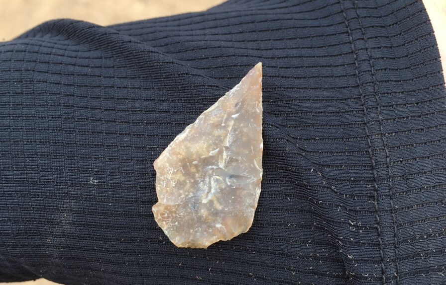 Image of Neolithic arrowhead being held, discovered near Beeford.